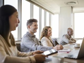 people in a business meeting smiling