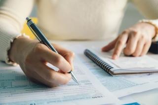 woman filling out tax forms