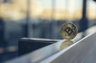 Bitcoin cryptocurrency on edge of office desk