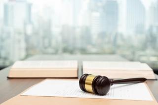 Gavel on desk with paperwork