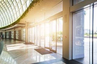 Sun shining through glass wall of modern office building