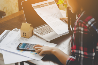 woman calculator laptop insurance documents