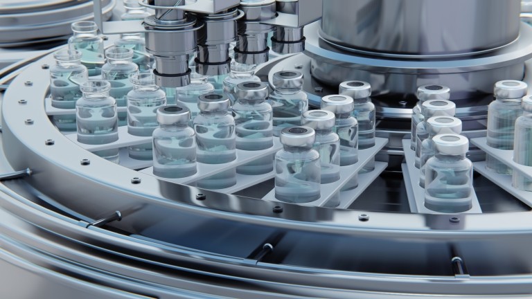 . Vaccine manufacturing, machine puts caps on bottles vials passing on conveyor belt
