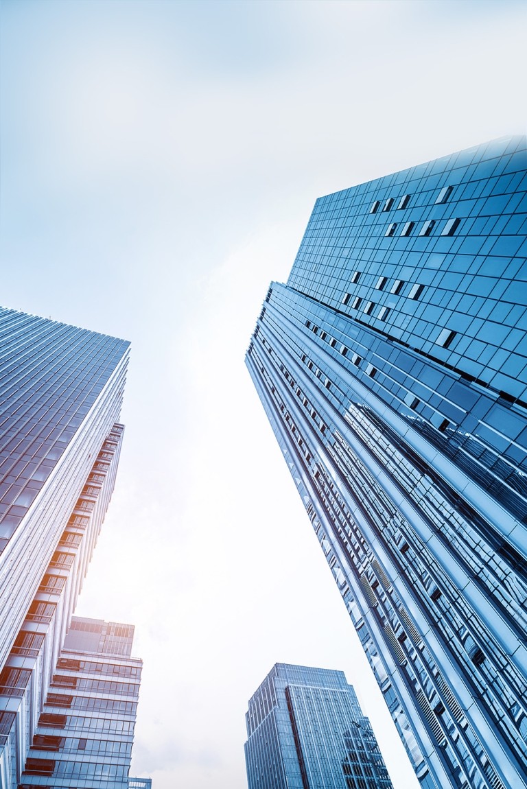 A cityscape with towering buildings against the sky