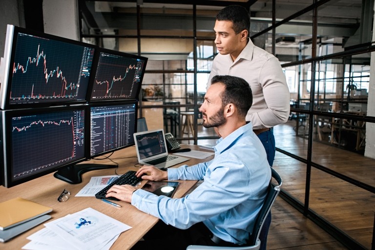 two men looking at stock market