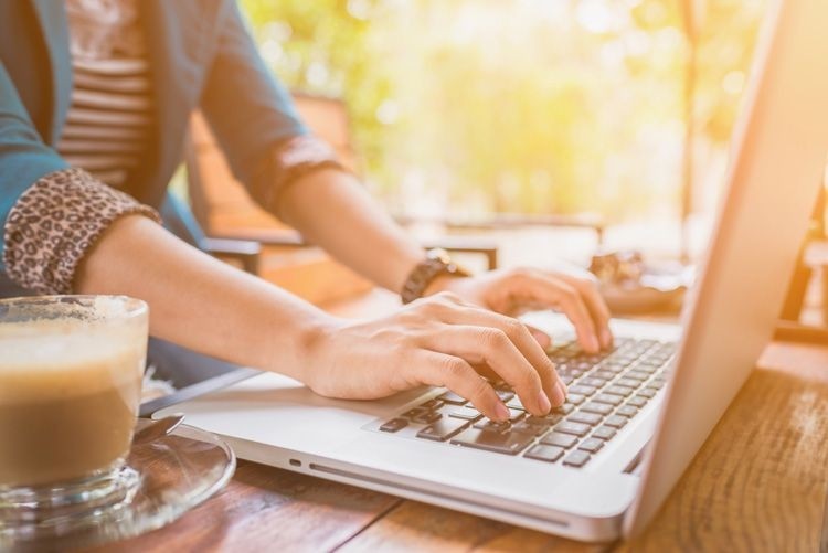 woman working laptop coffee remote