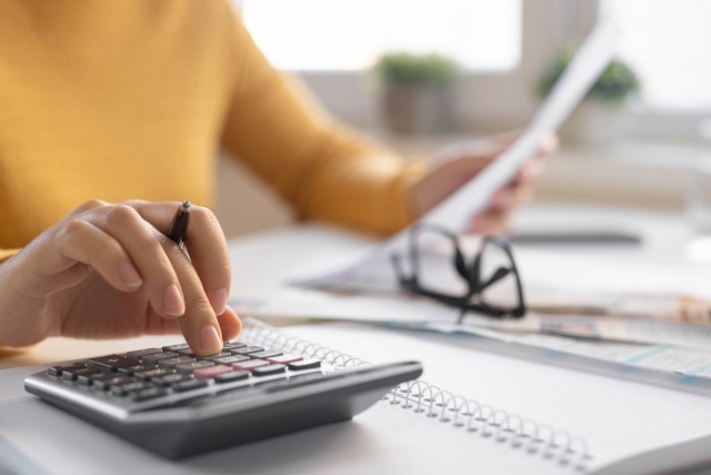 A person using a calculator to perform calculations