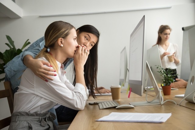 teammate comforting stressed frustrated female coworker upset