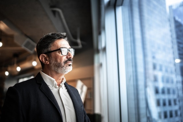 Mature businessman looking out of window