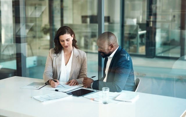 Man and woman looking over contract