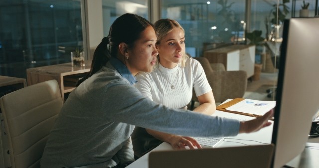 two women looking at computer screen