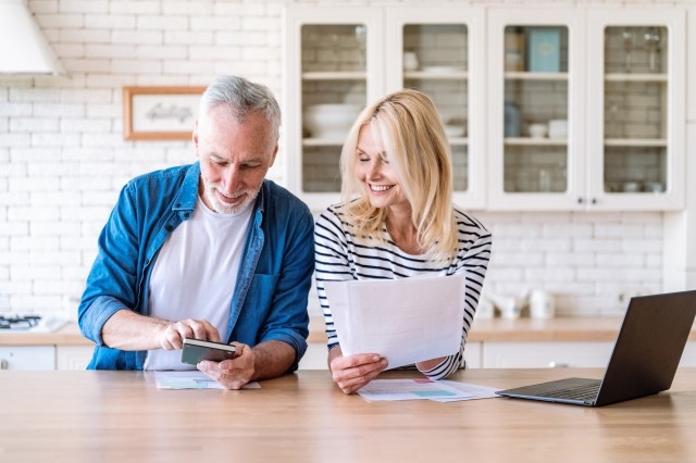 older couple looking at documents cheerfully