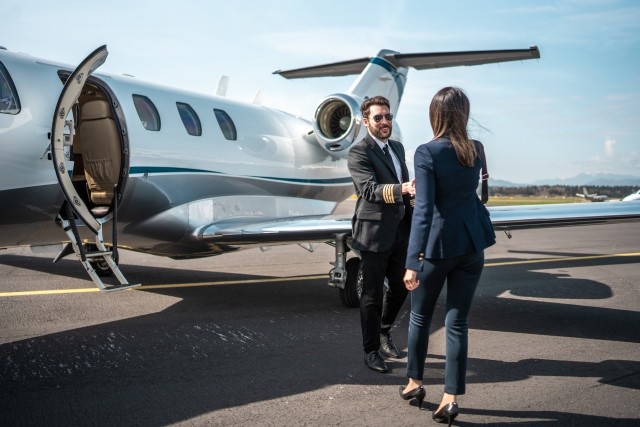 two business people outside of corporate jet