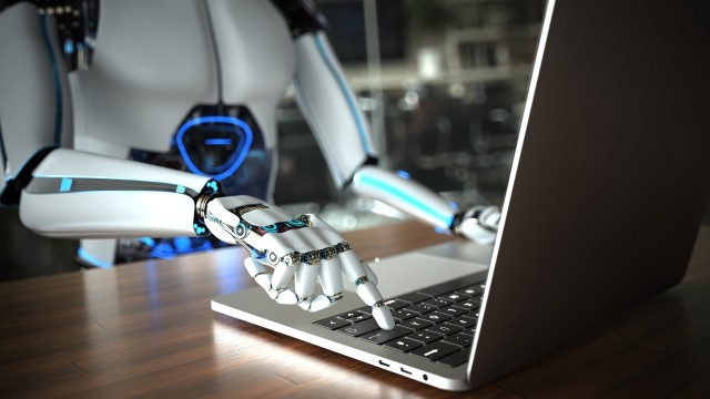 Robot humanoid using laptop 