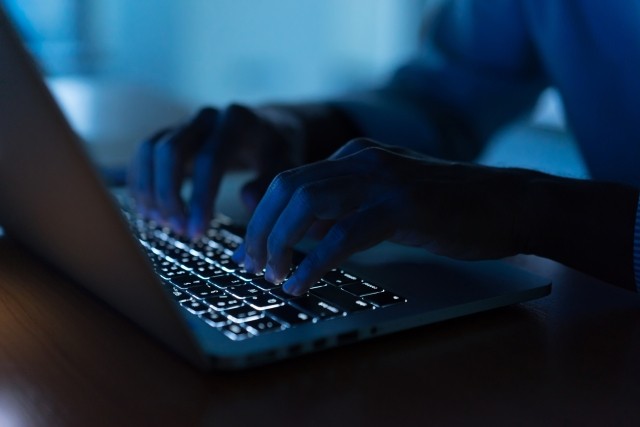 Close up programmer man hand typing on keyboard laptop for register data system