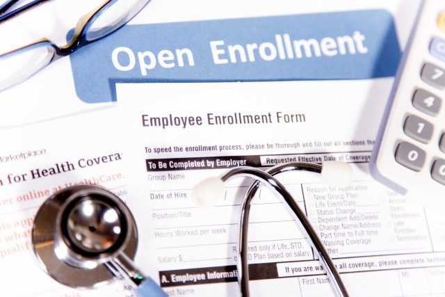 Healthcare benefit forms including: enrollment forms and applications, stethoscope, calculator