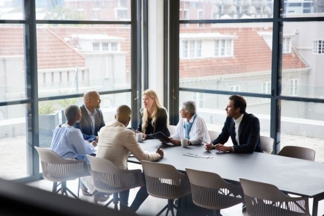Businesspeople talking together during a meeting in an office boardroom