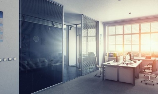 Meeting space in an office lit by the sunset stock photo used by Woodruff Sawyer.