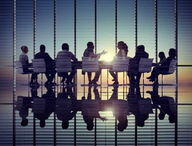 Diverse corporate boarding meeting stock photo used by Woodruff Sawyer.