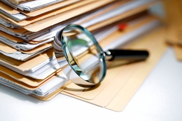 Magnifying glass over legal documents