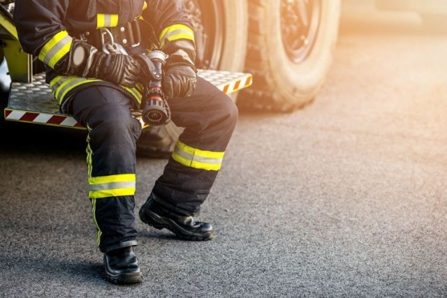 Firefighter in uniform sitting on bench