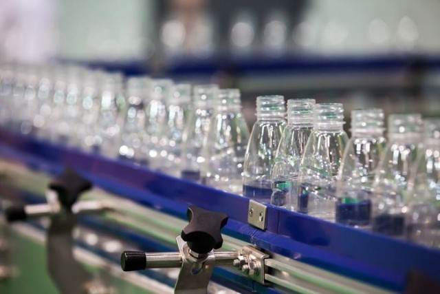 Bottles on conveyor belt at manufacturing plant