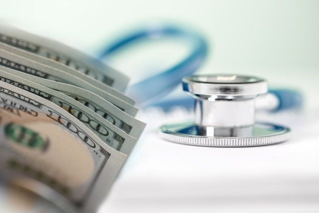 Stethoscope with money highlighting healthcare costs