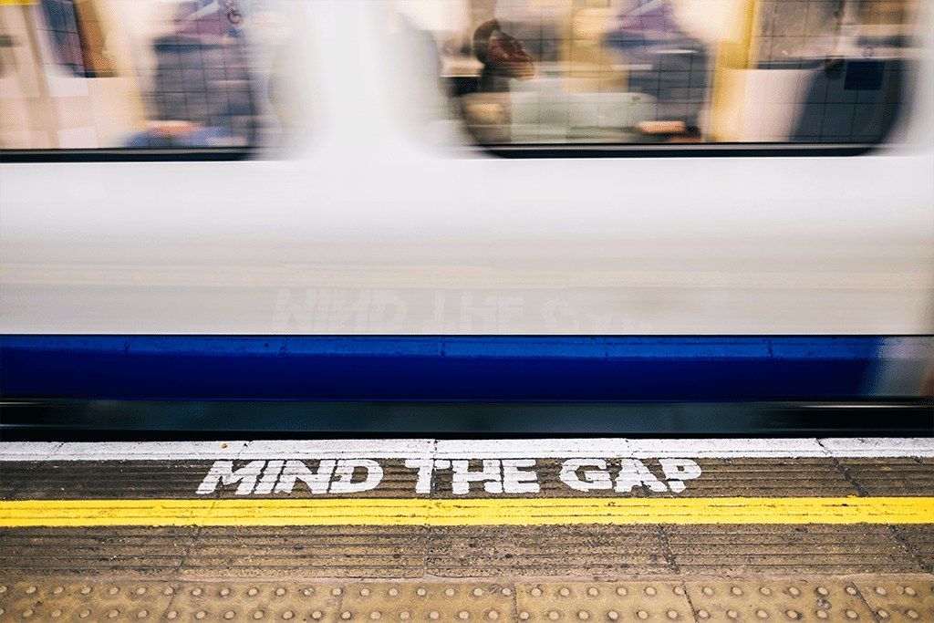 mind the gap sign and subway train