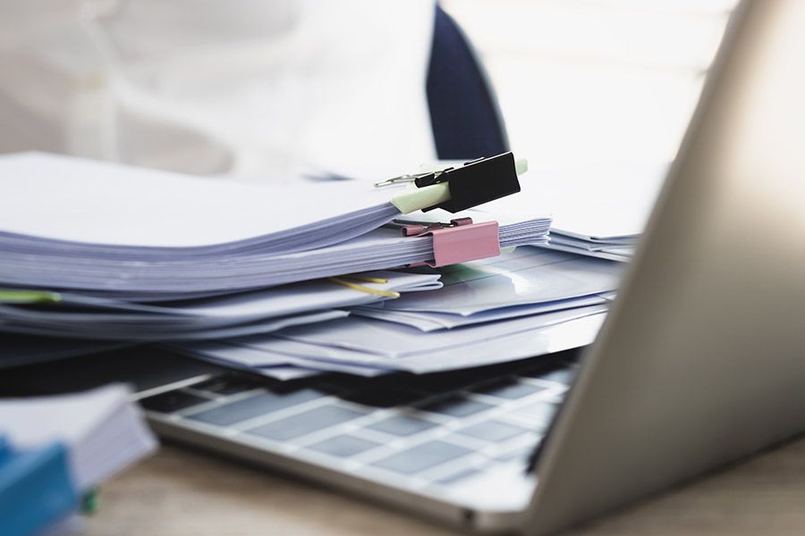 OSHA paperwork on top of laptop